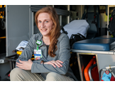 Ann Seaton sitting in the back of an ambulance
